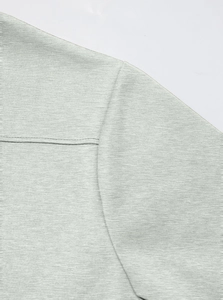 Detailed close-up showing the fine grey knit texture and shoulder seam stitching on the jacket