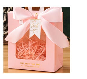 Pink luxury gift bag with transparent window, ribbon bow and gold thank you tag detail