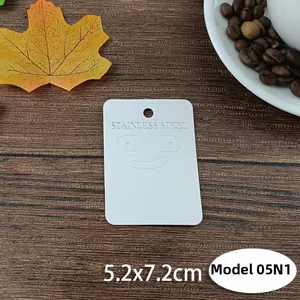 Close-up of Style 05N1 stainless steel jewelry display card on dark wood background