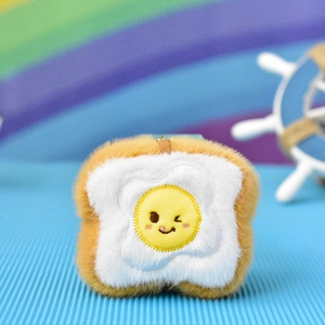 Cute plush toast keychain with embroidered fried egg face and soft fuzzy texture