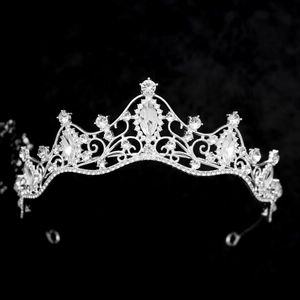 Detailed macro of a silver bridal crown with sparkling rhinestones on black background