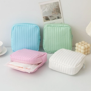 Quilted pastel PU leather pouches in four colors showing internal sanitary pad storage