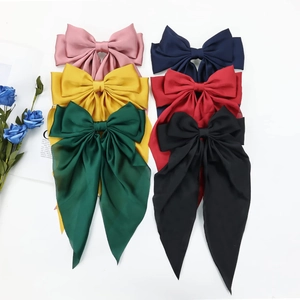 Selection of large satin bow hair clips in six vibrant colors including red and navy blue
