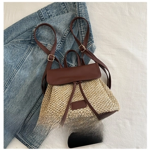 Close-up of mini straw backpack with brown leather flap next to a phone for size comparison