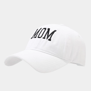 Detailed view of bold black MOM embroidery on white washed cotton baseball cap
