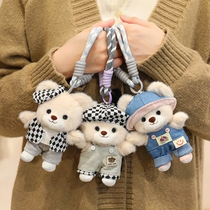 Three cute teddy bear plush keychains with stylish outfits and woven wrist straps