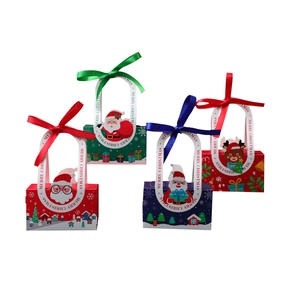 Set of 4 festive Christmas gift boxes with ribbons and Merry Christmas handles