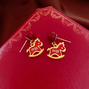 Festive red and gold rocking horse earrings with silver needles and lucky characters
