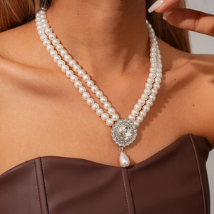 Detail of bohemian layered pearl necklace with turquoise rhinestone and teardrop pendant