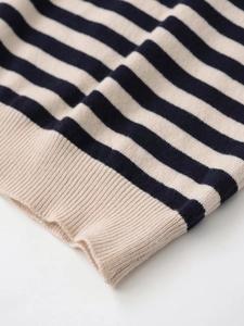 Detailed close-up of navy and beige striped knit top showing the fine ribbing texture