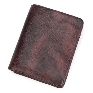 Detailed macro shot of deep brown genuine leather wallet texture with natural grain finish