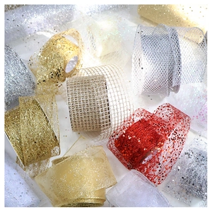 Close-up of sparkling glitter mesh ribbons in red, gold and silver for Christmas decor