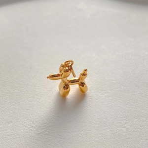 Polished 14K gold plated balloon dog charm pendant with a shiny mirror finish detail