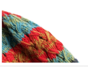 Macro shot of colorful chunky knit texture featuring vibrant wool blend yarn stitching