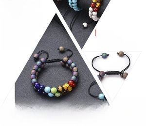 Detail of adjustable double-layer natural stone chakra beads with black braided cord