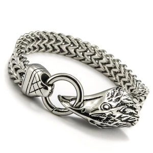 Macro detail of men's stainless steel Franco chain bracelet with a vintage wolf head clasp
