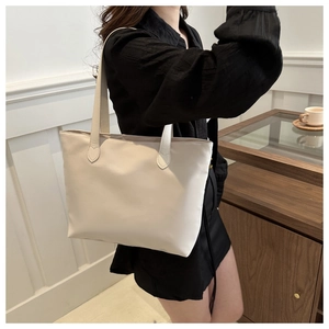 Model wearing a minimalist white tote bag with smooth finish for daily commuting