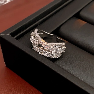 Close-up of a silver multi-layer ring with sparkling square zircon in a black jewelry box