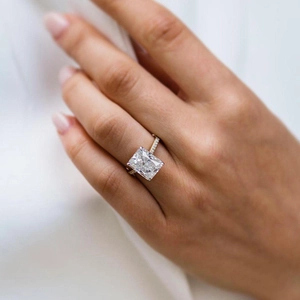 Elegant emerald cut zircon engagement ring with pave stones on white gold band