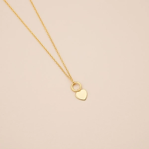 Elegant S925 sterling silver gold heart pendant necklace on minimalist pink background