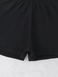 Close-up of elastic stitching and black fabric on high-waist swimming shorts