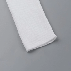 Detailed macro view of the ribbed knit texture and soft cotton blend fabric on white dress