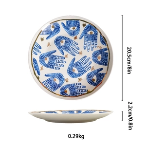 Detailed view of 8-inch ceramic plate featuring blue Hamsa hand and eye motifs with gold stars