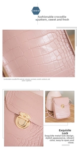 Detail view of pink crocodile pattern PU leather bag with golden metal buckle and texture