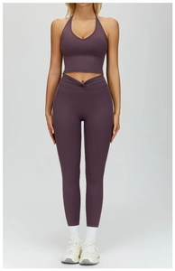 Detail of deep purple high-waist yoga leggings with V-shaped cross waist design