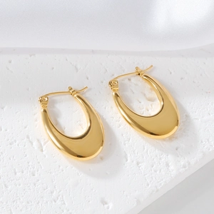 Detailed macro view of gold-plated U-shaped hoop earrings with polished finish