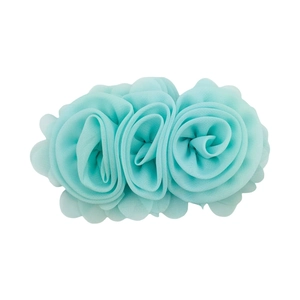 Close-up of three light blue chiffon rose flowers on a fabric hair clip accessory