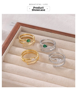 Detail of snake wrap rings with pear-cut gemstones and pavé crystals in a velvet box
