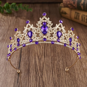 Detail showing purple crystal rhinestones on luxury baroque golden crown for weddings