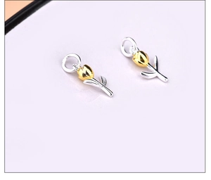 Detailed close-up of 925 silver tulip pendants with gold petals and silver stems for DIY jewelry
