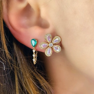 Detail of S925 silver flower stud and green teardrop earring with gold tassel