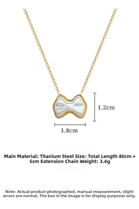 Detail view of gold titanium steel bow pendant with shell inlay and size measurements