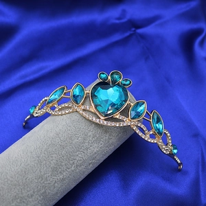 Detail of princess crown featuring heart-shaped blue crystal and silver rhinestones