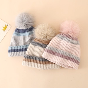 Three colorful striped knit beanies with soft faux fur pom-poms for winter warmth