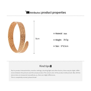 Detailed view of 9cm high gold iron cuff bracelet with intricate embossed floral patterns