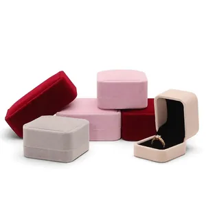 Velvet jewelry boxes in red, pink and grey with gold ring display and black lining
