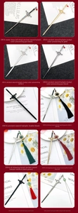 Close-up of Chinese sword hairpins with tassels, rubies, and oil drop craft details