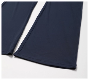 Detail of high-density navy blue yoga pants showing the flat-seam hem and elastic fabric