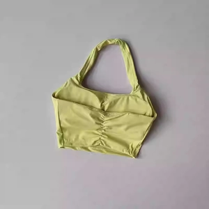 Close-up of ruched back detail and halter neck on light green fitness sports bra