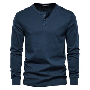 Close-up of deep blue Henley shirt featuring a three-button placket and soft cotton texture