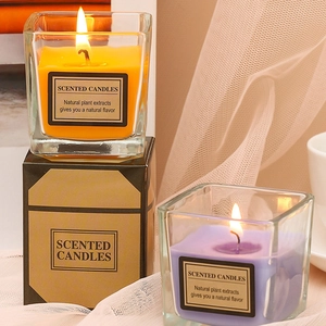 Scented glass jar candles in orange and purple with elegant black gift box packaging