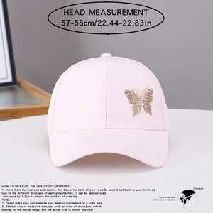 Detail of pink baseball cap featuring rhinestone butterfly decor and size measurements