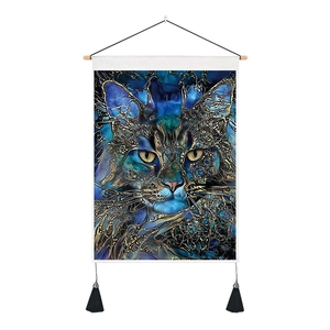 Detail of bohemian 3D cat tapestry with blue and gold art, wooden rod, and black tassels