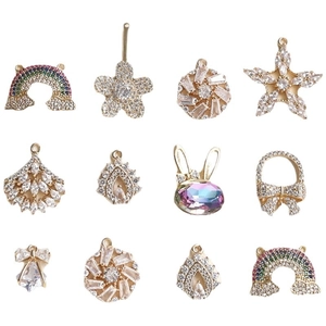 Colorful zircon-encrusted charms featuring rainbow, flower, and star shapes on gold base