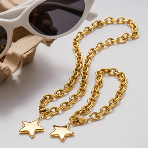 Macro shot of gold star pendant necklace with chunky links and polished finish