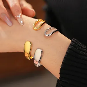 Minimalist gold and silver teardrop open cuff bracelet with sleek irregular fluid design